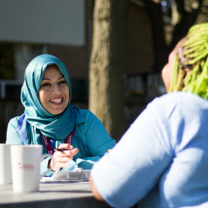 woman smiling at another woman